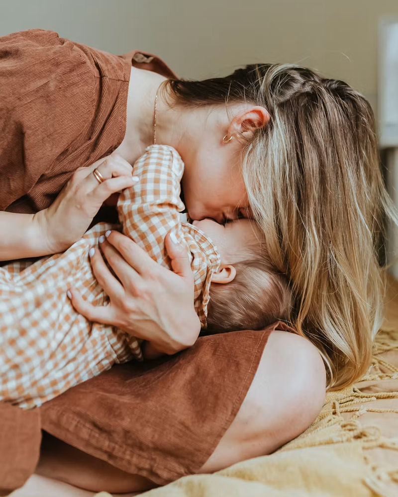 A parent holding a sleeping child
